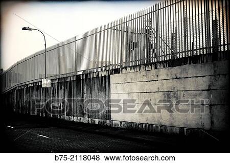 Wall, fence and lamppost in a industrial area. London, England, UK, Europe. View Large Photo Image Stock Photo - Wall, fence and lamppost in a industrial area. London, England, UK, Europe.. Fotosearch