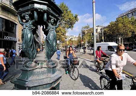 Wallace fountain. Designed by Charles-Auguste Lebourg. Financed by Richard Wallace. Intersection Gran Via with Passeig de Gr? cia. It's one of the 2 remaining of the 12 fountains donated to Barcelona for the 1888 World Fair. Barcelona. Catalonia. Spain. View Large Photo Image Picture - Wallace fountain. Designed by Charles-Auguste Lebourg. Financed by Richard Wallace. Intersection Gran Via with Passeig de Gr? cia. It's one of the 2 remaining of the 12 fountains donated to Barcelona for the 1888 World Fair. Barcelona. Catalonia. Spain.. Fotosearch