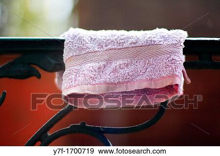 Stock Photo - Washing mitt hanging on a steel guardrail. Fotosearch