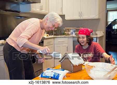 Washington, DC - 13 year old boy and his aunt, 62, make a gingerbread house View Large Photo Image Stock Photograph - Washington, DC - 13 year old boy and his aunt, 62, make a gingerbread house. Fotosearch