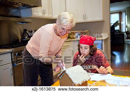 Washington, DC - 13 year old boy and his aunt, 62, make a gingerbread house View Large Photo Image Stock Photography - Washington, DC - 13 year old boy and his aunt, 62, make a gingerbread house. Fotosearch