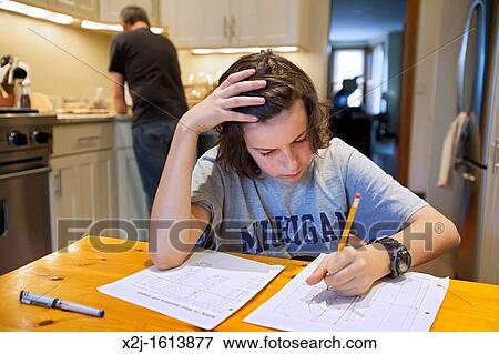 Washington, DC - 13 year old boy does homework in his family's kitchen View Large Photo Image Stock Photo - Washington, DC - 13 year old boy does homework in his family's kitchen. Fotosearch