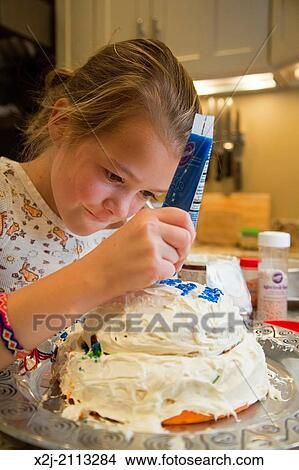 Washington, DC - Elizabeth Elliott, 10, decorates a cake for her grandfather's birthday. View Large Photo Image Picture - Washington, DC - Elizabeth Elliott, 10, decorates a cake for her grandfather's birthday.. Fotosearch