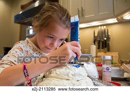 Washington, DC - Elizabeth Elliott, 10, decorates a cake for her grandfather's birthday. View Large Photo Image Stock Photography - Washington, DC - Elizabeth Elliott, 10, decorates a cake for her grandfather's birthday.. Fotosearch