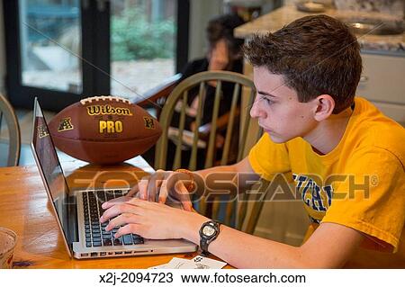 Washington, DC - High school freshman, 15, works on his laptop computer. View Large Photo Image Stock Image - Washington, DC - High school freshman, 15, works on his laptop computer.. Fotosearch
