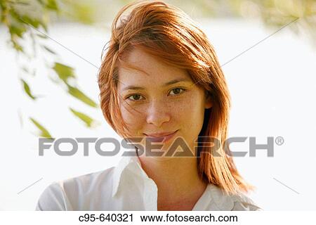 Stock Image - Washington, DC, USA, Portrait of a woman, with cell phone and laptop, Adult, 23 years old, Asian.. Fotosearch