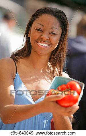 Stock Photo - Washington, DC, USA, Portrait of a woman on the market, book and drug stores, African American, Adult, 30 years old.. Fotosearch