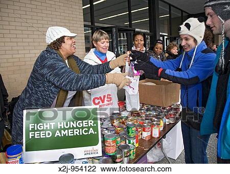 Stock Image - Washington, DC - Volunteers collect canned goods for food banks The project was one of many Martin Luther King Day community service projects the day before the Presidential inauguration of Barack Obama. Fotosearch