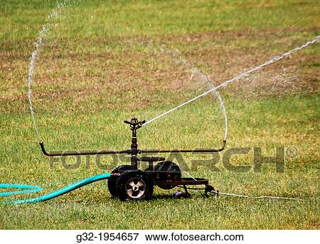 Stock Photo - Wasteful irrigation (evaporating).. Fotosearch