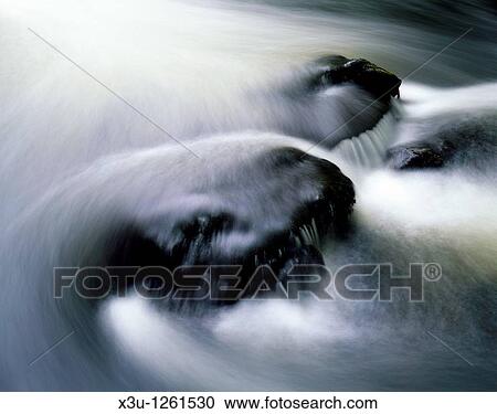 Water flowing over rocks in the River Teign in the Dartmoor National Park, Devon, England, United Kingdom View Large Photo Image Stock Image - Water flowing over rocks in the River Teign in the Dartmoor National Park, Devon, England, United Kingdom. Fotosearch
