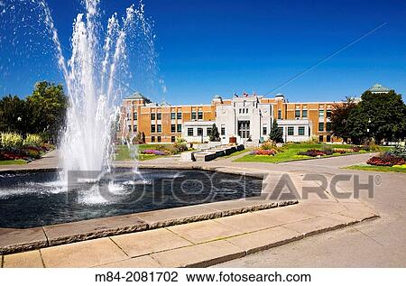 Stock Image - Water fountain and administration building in summer at the Montreal Botanical Garden, Montreal, Quebec, Canada.. Fotosearch