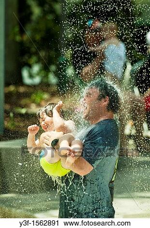 Stock Image - Water fun in the water feature park on the banks of the Brisbane River in Brisbane, Australia. Fotosearch