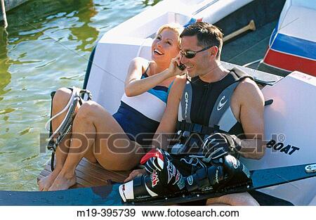 water skiing couple on cell phone View Large Photo Image Stock Photo - water skiing couple on cell phone. Fotosearch