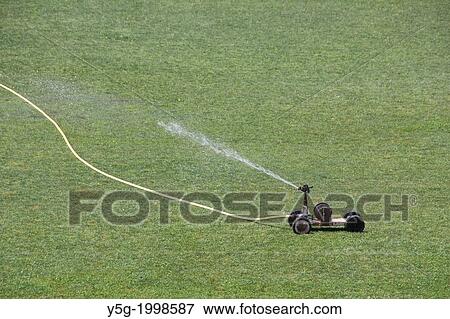 water sprinkler on sports field in rome italy. View Large Photo Image Stock Photo - water sprinkler on sports field in rome italy.. Fotosearch