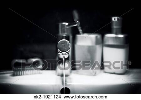 Picture - water stream in the washbasin (waste). Fotosearch