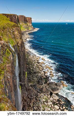 Waterfall flowing over the cliffs of the coast of Isle of Skye, Kilt Rock is in the distance, Trotternish, Scotland, UK, Europe View Large Photo Image Stock Image - Waterfall flowing over the cliffs of the coast of Isle of Skye, Kilt Rock is in the distance, Trotternish, Scotland, UK, Europe. Fotosearch