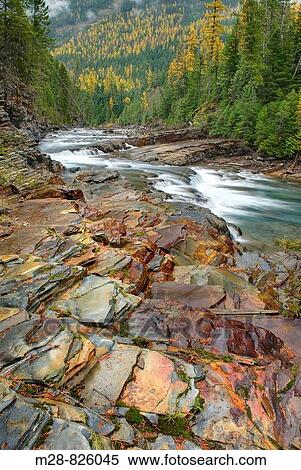 Waterfalls tumbling over layered sedimentary rocks of McDonald Creek, Glacier National Park Montana USA View Large Photo Image Stock Photography - Waterfalls tumbling over layered sedimentary rocks of McDonald Creek, Glacier National Park Montana USA. Fotosearch