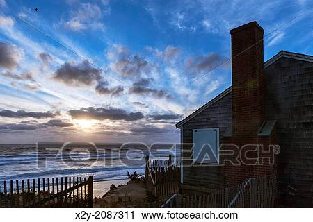Waterfront beach cottage at sunrise. View Large Photo Image Stock Image - Waterfront beach cottage at sunrise.. Fotosearch