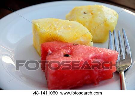 Stock Image - Watermelon and pineapple on plate. Fotosearch