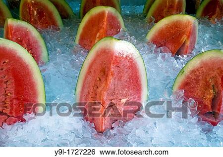 Watermelon on ice in a grocery store in New York View Large Photo Image Stock Photograph - Watermelon on ice in a grocery store in New York. Fotosearch