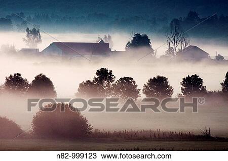 Stock Image - Watermill? Schmalzmuehle? at the woernitz river in morning mist - Middle Franconia, Bavaria/Germany. Fotosearch