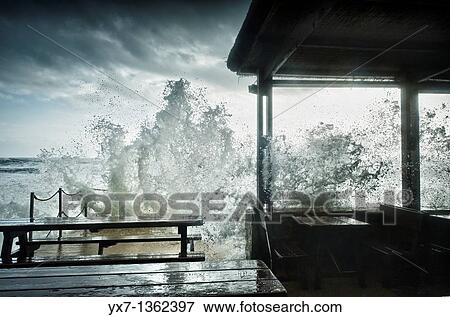 Stock Photo - Waves breaking against bar terrace. Costa de la Luz, Cadiz province, Spain. Fotosearch