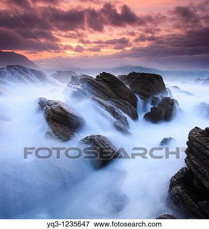 Waves breaking against the coast in Cerdigo, Castro Urdiales, Cantabria, Spain View Large Photo Image Stock Photo - Waves breaking against the coast in Cerdigo, Castro Urdiales, Cantabria, Spain. Fotosearch