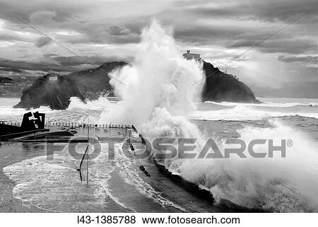 Stock Photo - Waves breaking in a storm in San Sebastian, Basque country. Fotosearch