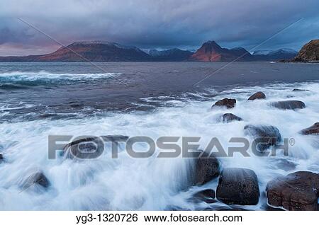 Waves crash over rocky shore at Elgol, Isle of Skye, Scotland View Large Photo Image Stock Photograph - Waves crash over rocky shore at Elgol, Isle of Skye, Scotland. Fotosearch