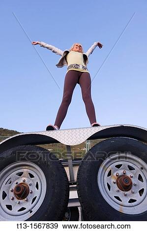 Waving to someone, young woman atop the truck View Large Photo Image Stock Photo - Waving to someone, young woman atop the truck. Fotosearch