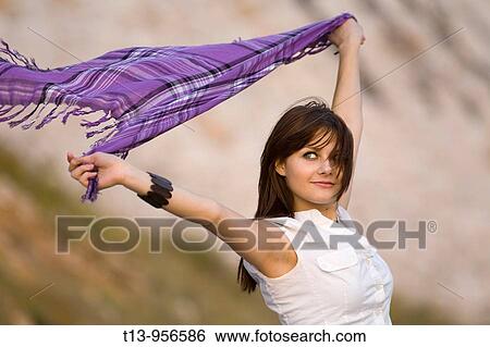 Stock Photograph - Waving with scarf young woman. Fotosearch