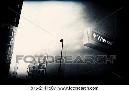 Way out sign post seen through a glass with reflections of buildings and lamp post in the street. London, England, UK, Europe. View Large Photo Image Stock Photo - Way out sign post seen through a glass with reflections of buildings and lamp post in the street. London, England, UK, Europe.. Fotosearch