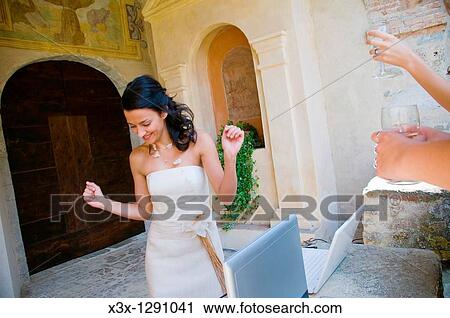 Stock Image - Wedding bride dancing at a reception. Fotosearch
