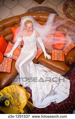 Wedding bride sitting on couch View Large Photo Image Stock Photo - Wedding bride sitting on couch. Fotosearch