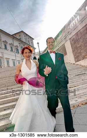 Wedding couple descending stairs at Quirinale Rome Italy View Large Photo Image Stock Photography - Wedding couple descending stairs at Quirinale Rome Italy. Fotosearch
