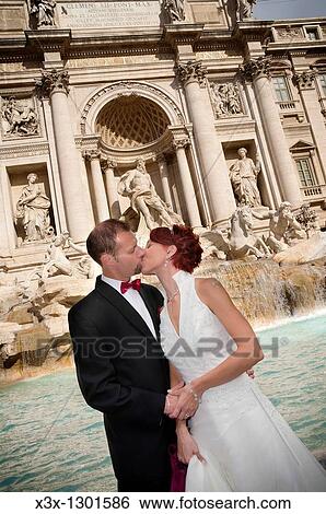 Wedding couple kissing in front of Fontana di Trevi Rome Italy View Large Photo Image Stock Photograph - Wedding couple kissing in front of Fontana di Trevi Rome Italy. Fotosearch