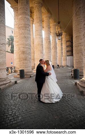 Wedding couple kissing underneath the Colonnade of Saint Peter's square Vatican Rome Italy View Large Photo Image Stock Photograph - Wedding couple kissing underneath the Colonnade of Saint Peter's square Vatican Rome Italy. Fotosearch