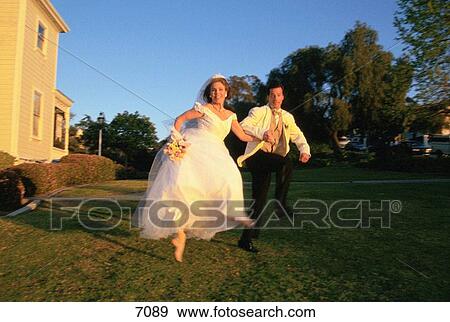 Stock Photo - Wedding couple leap in air. Fotosearch