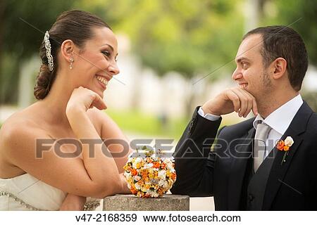 Wedding couple looking and laughing View Large Photo Image Stock Photo - Wedding couple looking and laughing. Fotosearch