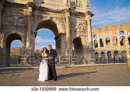 Wedding couple standing in front of the Constantine's arc in Rome Italy View Large Photo Image Stock Photo - Wedding couple standing in front of the Constantine's arc in Rome Italy. Fotosearch