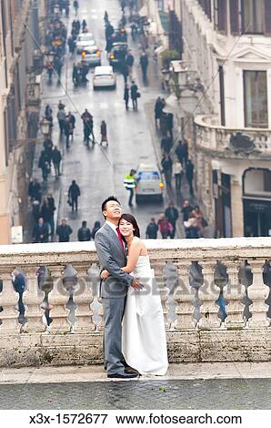 Wedding couple standing on the terrace by the Spanish steps in Rome Italy View Large Photo Image Stock Photo - Wedding couple standing on the terrace by the Spanish steps in Rome Italy. Fotosearch