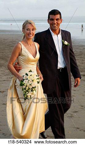 wedding couple walking on the beach View Large Photo Image Picture - wedding couple walking on the beach. Fotosearch