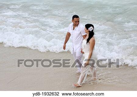 Wedding couple walking on the beach, Miami Beach, Florida, USA. View Large Photo Image Stock Image - Wedding couple walking on the beach, Miami Beach, Florida, USA.. Fotosearch