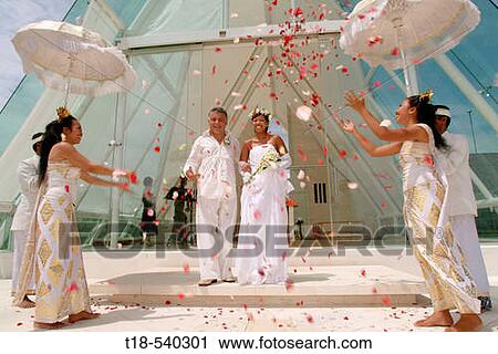 wedding couple walking trough flowers shower View Large Photo Image Stock Image - wedding couple walking trough flowers shower. Fotosearch