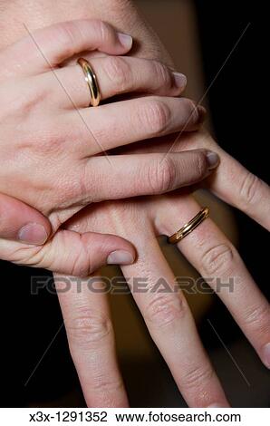 Wedding rings on each other hands View Large Photo Image Stock Image - Wedding rings on each other hands. Fotosearch