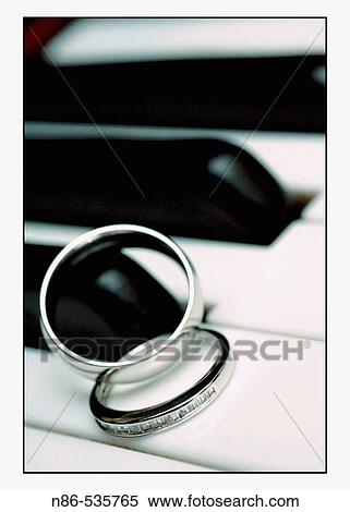 Stock Photography - Wedding rings on piano keys. Fotosearch