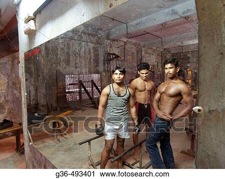 Stock Image - Weighlifters look in mirror. Dhaka, Bangladesh. Fotosearch