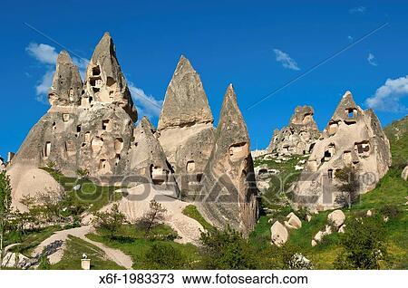 Stock Image - Weirdly shaped tuff rocks with storage rooms at the UNESCO World Heritage site Goreme National Park and the Rock Sites of Cappadocia, Uchisar, Anatolia, Turkey.. Fotosearch
