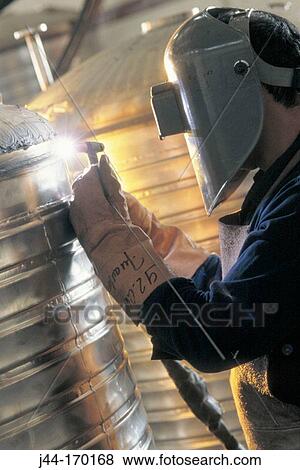 Welder welding a metal tank View Large Photo Image Stock Photo - Welder welding a metal tank. Fotosearch