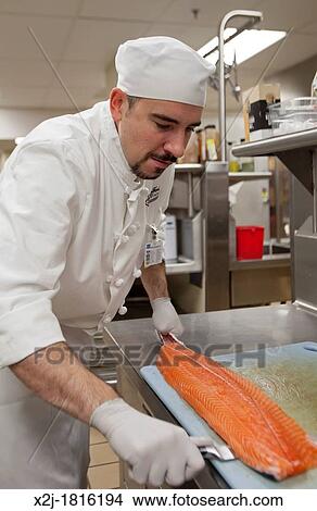 West Bloomfield, Michigan - Chef Jay Lovell prepares salmon for patient meals in the kitchen of Henry Ford West Bloomfield Hospital View Large Photo Image Picture - West Bloomfield, Michigan - Chef Jay Lovell prepares salmon for patient meals in the kitchen of Henry Ford West Bloomfield Hospital. Fotosearch
